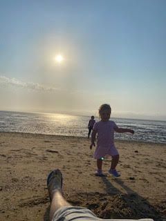 Child on the beach at sunset
