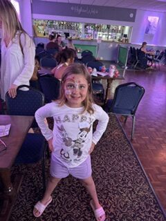 A smiling girl at a community event